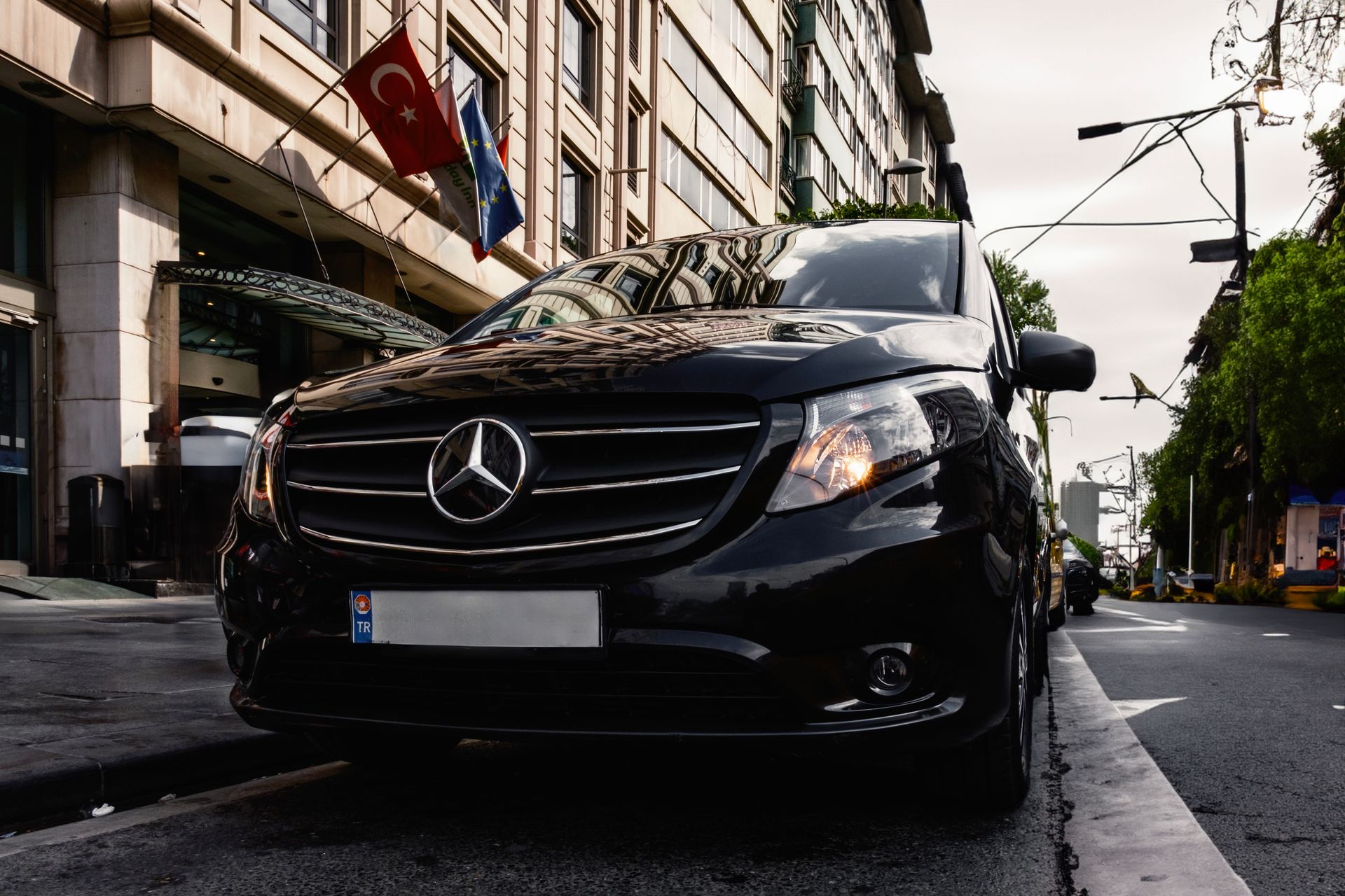 Luxury black Mercedes-Benz Vito parked on a Turkish city street, capturing urban elegance.
