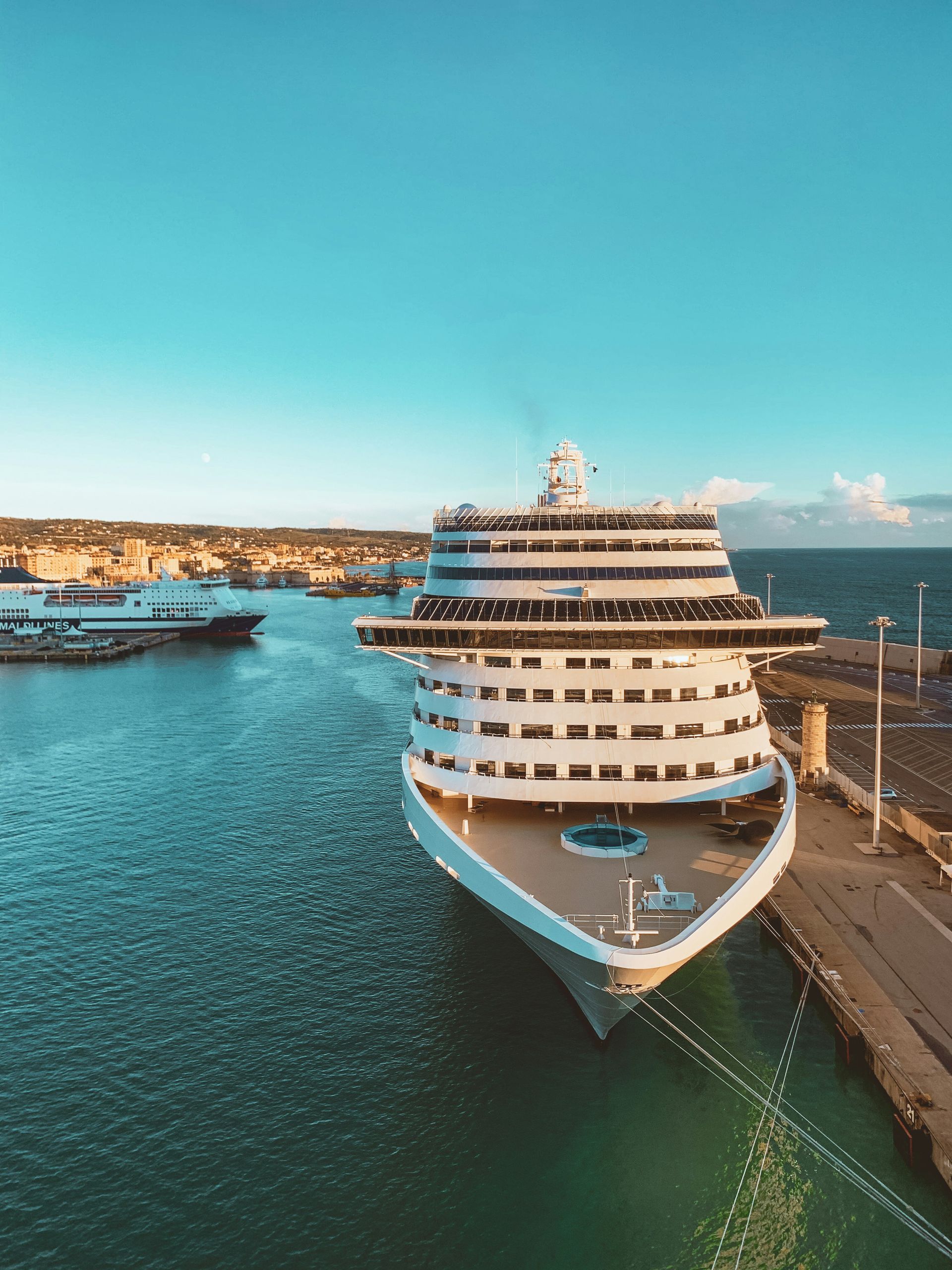 white and blue cruise ship on sea under blue sky during daytime